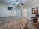 Comfortable main bedroom with a king-size bed and ceiling fan at 1710 Hilton Head Blvd, The Villages, FL 32159