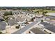Bird's eye view showcases a residential area with manicured lawns, diverse home styles, and well-maintained streets and landscaping at 17159 Se 78Th Crowfield Ave, The Villages, FL 32162