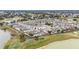 Beautiful aerial view of a residential community with well-maintained landscaping and a nearby golf course and several ponds at 17159 Se 78Th Crowfield Ave, The Villages, FL 32162