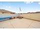A spacious concrete patio with a fire pit and an American flag on display in the backyard at 17159 Se 78Th Crowfield Ave, The Villages, FL 32162