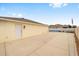The back of the house features a spacious concrete patio with a fire pit and access to side yard at 17159 Se 78Th Crowfield Ave, The Villages, FL 32162