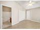 Bright bedroom with ceiling fan, closet and ensuite bathroom at 17159 Se 78Th Crowfield Ave, The Villages, FL 32162