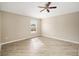 Neutral bedroom featuring a ceiling fan, wood floors, and a window that provides natural light at 17159 Se 78Th Crowfield Ave, The Villages, FL 32162