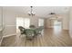 Dining area with wicker furniture, seamlessly connecting to an outdoor patio and bright living spaces at 17159 Se 78Th Crowfield Ave, The Villages, FL 32162