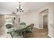 Dining area featuring wicker furniture, seamlessly connecting to the pool and other living spaces at 17159 Se 78Th Crowfield Ave, The Villages, FL 32162