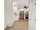 Open-concept kitchen featuring white cabinetry, stainless steel appliances, granite countertops, and wood-look flooring at 17159 Se 78Th Crowfield Ave, The Villages, FL 32162
