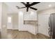 Well-equipped kitchen features ample white cabinets, granite countertops, stainless appliances and wood-look floors at 17159 Se 78Th Crowfield Ave, The Villages, FL 32162