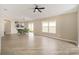 Open-concept living area with dining space, wood floors, neutral tones, and large windows for plenty of natural light at 17159 Se 78Th Crowfield Ave, The Villages, FL 32162