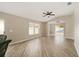 Open floor plan showcasing wood floors, vaulted ceilings, and access to a pool area through sliding glass doors at 17159 Se 78Th Crowfield Ave, The Villages, FL 32162
