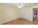 Bedroom with hardwood floors, yellow walls, a ceiling fan, and a closet at 17848 Se 87Th Bourne Ave, The Villages, FL 32162