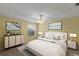 Cozy bedroom with neutral walls, ceiling fan, carpet flooring, and modern furnishings creating a welcoming space at 17848 Se 87Th Bourne Ave, The Villages, FL 32162
