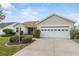 Charming single-story home featuring a well-manicured front yard and an attached two-car garage at 17848 Se 87Th Bourne Ave, The Villages, FL 32162