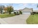 Charming single-story home featuring a well-manicured front yard and an attached two-car garage at 17848 Se 87Th Bourne Ave, The Villages, FL 32162