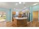 Spacious kitchen with stainless steel appliances, breakfast bar, and modern lighting at 17848 Se 87Th Bourne Ave, The Villages, FL 32162