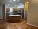 Updated kitchen featuring stainless steel appliances, a peninsula island, and wood cabinetry at 17848 Se 87Th Bourne Ave, The Villages, FL 32162