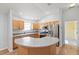 Bright eat-in kitchen features stainless appliances, wood cabinets, and a breakfast bar with laminate countertops at 17848 Se 87Th Bourne Ave, The Villages, FL 32162