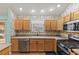 Well-lit kitchen features natural wood cabinetry, modern appliances, and bright countertops at 17848 Se 87Th Bourne Ave, The Villages, FL 32162