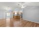 Open living area with wood floors flows into a kitchen with stainless steel appliances and a center island at 17848 Se 87Th Bourne Ave, The Villages, FL 32162