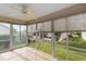 Relaxing enclosed porch with panoramic views, tiled flooring, and a ceiling fan for outdoor enjoyment at 17848 Se 87Th Bourne Ave, The Villages, FL 32162