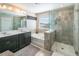 Elegant bathroom with double vanity, soaking tub, and walk-in shower at 1827 Merrivale Loop, Ocoee, FL 34761