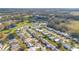 Aerial view of community with homes, golf course, and pond at 200 Willow Brook Dr, Leesburg, FL 34748