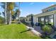 Backyard patio area with lush greenery and a view of the pond at 2247 Cypress Cove Dr # E2, Tavares, FL 32778