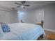 A cozy bedroom with a bed, a ceiling fan and hardwood floors at 2247 Cypress Cove Dr # E2, Tavares, FL 32778