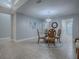 Stylish dining room featuring a glass table, carved wood chairs, and elegant chandelier, perfect for gatherings at 2247 Cypress Cove Dr # E2, Tavares, FL 32778