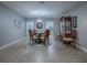 Stylish dining room featuring a glass table, carved wood chairs, and elegant chandelier, perfect for gatherings at 2247 Cypress Cove Dr # E2, Tavares, FL 32778