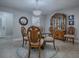 Stylish dining room featuring a glass table, carved wood chairs, and elegant chandelier, perfect for gatherings at 2247 Cypress Cove Dr # E2, Tavares, FL 32778