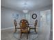 Stylish dining room featuring a glass table, carved wood chairs, and elegant chandelier, perfect for gatherings at 2247 Cypress Cove Dr # E2, Tavares, FL 32778
