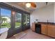 Enclosed Florida room with a mini-fridge, wet bar, and an exterior door at 2247 Cypress Cove Dr # E2, Tavares, FL 32778