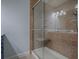 Modern shower with glass door, bench, grab bar, and multi-setting shower head at 2247 Cypress Cove Dr # E2, Tavares, FL 32778