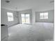Bright living room with abundant natural light, sliding glass doors to outdoor space, and modern chandelier at 2827 Supermarine Rd, Tavares, FL 32778