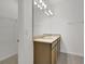 Bathroom with double vanity, large mirror, and walk-in closet at 2884 Supermarine Rd, Tavares, FL 32778