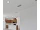 Open concept kitchen area with wooden cabinets and stainless appliances at 2884 Supermarine Rd, Tavares, FL 32778