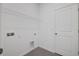 A practical laundry room with tiled floors, utility connections, and wire shelving for storage at 2884 Supermarine Rd, Tavares, FL 32778