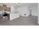 Open concept living space features tiled floors leading to modern kitchen with island at 2884 Supermarine Rd, Tavares, FL 32778