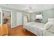 Charming bedroom with wood floors, a ceiling fan and access to a full bath at 2907 Barboza Dr, The Villages, FL 32162