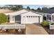 White house with a white picket fence and a two-car garage at 2907 Barboza Dr, The Villages, FL 32162