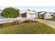 Front view of a house with white picket fence, landscaping, and driveway at 2907 Barboza Dr, The Villages, FL 32162