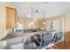 Kitchen with light wood cabinets, breakfast bar, and tile flooring at 2907 Barboza Dr, The Villages, FL 32162