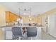 Kitchen boasts light wood cabinets, breakfast bar and tile floor at 2907 Barboza Dr, The Villages, FL 32162