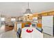 Kitchen with wood cabinets, breakfast bar, and open layout at 2907 Barboza Dr, The Villages, FL 32162