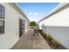 Small patio with table and chairs between two houses at 2907 Barboza Dr, The Villages, FL 32162
