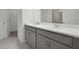 Bright bathroom showcasing a double vanity with gray cabinets and white countertop at 2992 Supermarine Rd, Tavares, FL 32778