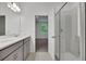 Modern bathroom featuring double vanity, glass enclosed shower, and neutral color palette at 2992 Supermarine Rd, Tavares, FL 32778