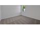 Cozy bedroom featuring neutral carpet and bright natural light from the window at 2992 Supermarine Rd, Tavares, FL 32778