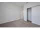 Carpeted bedroom featuring closet and natural light at 2992 Supermarine Rd, Tavares, FL 32778