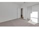 Bright bedroom with carpet flooring, closet, and a connecting doorway at 2992 Supermarine Rd, Tavares, FL 32778